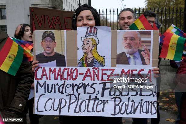 Supporter of President Evo Morales holds a placard during the demonstration. People gathered outside Downing Street to raise their voices against the...