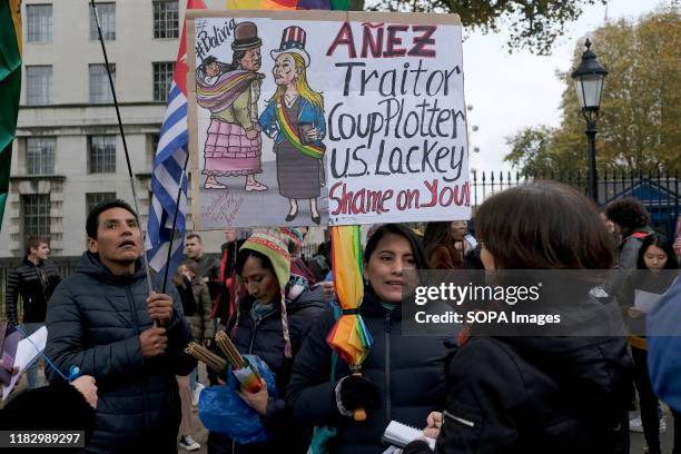 Supporter of President Evo Morales holds a placard during the demonstration. People gathered outside Downing Street to raise their voices against the...