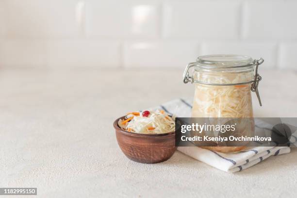 sauerkraut in glass mason jar. pickling cabbage at home on table. the best natural probiotic. homemade kraut., copy space for text - sauerkraut stock pictures, royalty-free photos & images