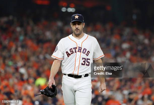 Justin Verlander of the Houston Astros walks off the field after retiring the side in the first inning against Washington Nationals in Game Two of...