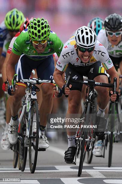 Stage winner, Britain's Mark Cavendish sprints on the finish line as he wins ahead of third-placed, Green jersey of best sprinter, Jose Joaquim Rojas...