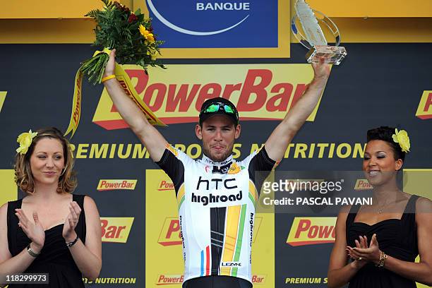 Britain's Mark Cavendish celebrates on the podium after winning the 164.5 km and fifth stage of the 2011 Tour de France cycling race run between...