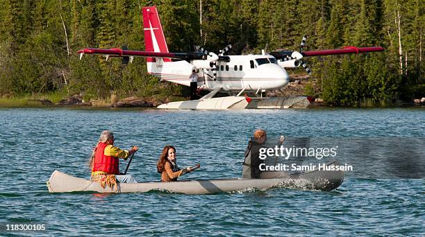 Prince William, Duke of Cambridge and Catherine, Duchess of Cambridge row a canoe to 'Honeymoon Island' on July 5, 2011 in Blatchford Lake, Canada.