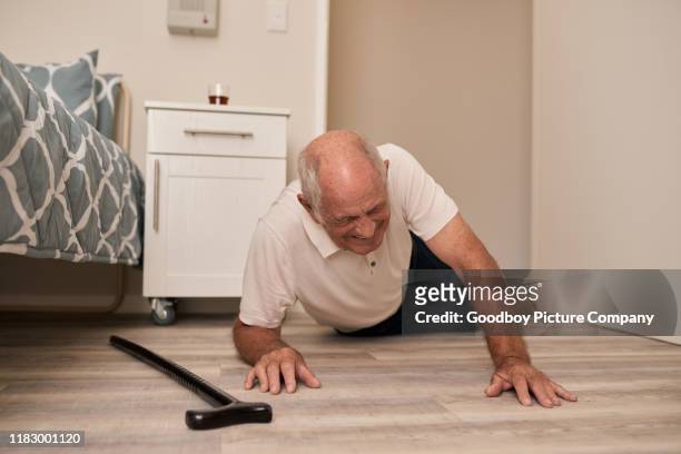senior man grimacing in pain after a fall - drop stock pictures, royalty-free photos & images