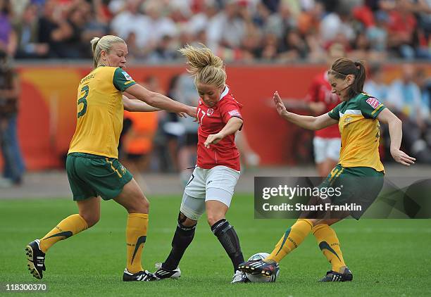 Lene Mykjaland of Norway is challenged by Kim Carroll and Clare Polkinghorne of Australia during the FIFA Women's World Cup 2011 group D match...