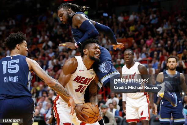 Chris Silva of the Miami Heat is fouled by Jae Crowder and Brandon Clarke of the Memphis Grizzlies during the second half at American Airlines Arena...
