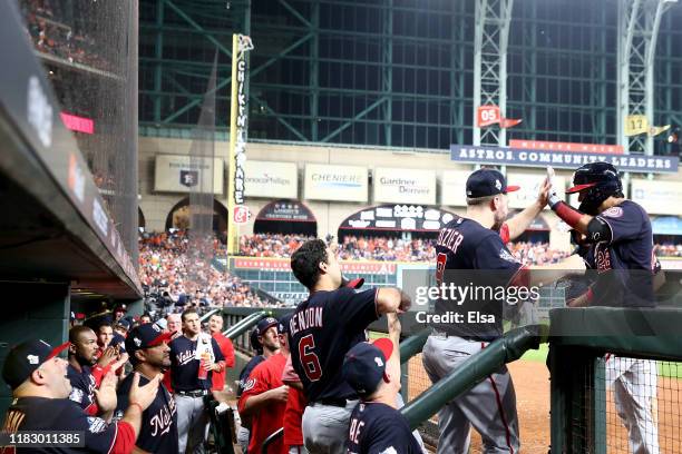 Kurt Suzuki of the Washington Nationals is congratulated by teammates after hitting a solo home run against the Houston Astros during the seventh...