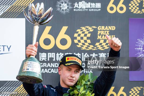 Hitech Grand Prix driver Juri Vips of Estonia poses for photo with trophy after finished in second place of the formula 3 Macau Grand Prix - FIA F3...
