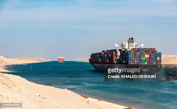 This picture taken on November 17, 2019 shows the Liberia-flagged container ship RDO Concord sailing through Egypt's Suez Canal in the canal's...