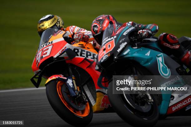 Repsol Honda Team's Spanish rider Marc Marquez and Petronas Yamaha SRT's French rider Fabio Quartararo ride during the MotoGP race of the MotoGP...