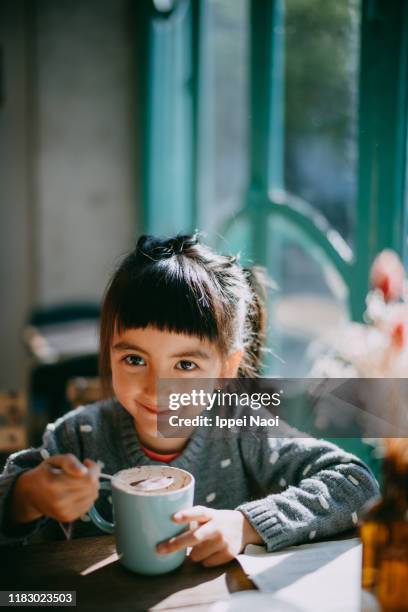 cute young girl enjoying hot chocolate - hot chocolate stock pictures, royalty-free photos & images