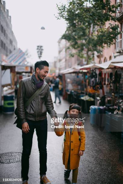 father and child walking in market in amsterdam - asian tourist bildbanksfoton och bilder