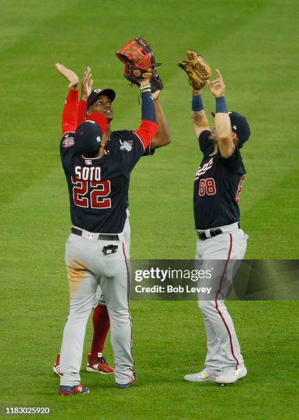 Juan Soto, Michael A. Taylor and Gerardo Parra of the Washington Nationals celebrate their 12-3 win over the Houston Astros in Game Two of the 2019...