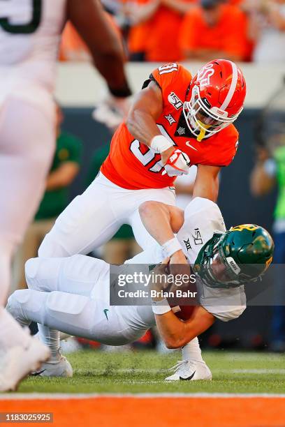 Quarterback Charlie Brewer of the Baylor University Bears falls just short of the goal line under the eye of safety Kolby Harvell-Peel of the...