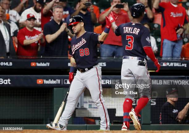 Michael A. Taylor of the Washington Nationals is congratulated by his teammate Gerardo Parra after he hits a solo home run against the Houston Astros...