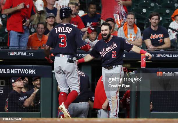 Michael A. Taylor of the Washington Nationals is congratulated by his teammate Adam Eaton after he hits a solo home run against the Houston Astros...