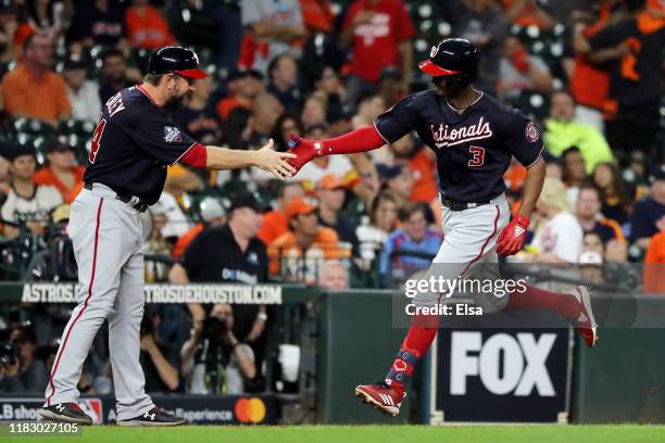 Michael A. Taylor of the Washington Nationals is congratulated by his third base coach Bob Henley after he hits a solo home run against the Houston...
