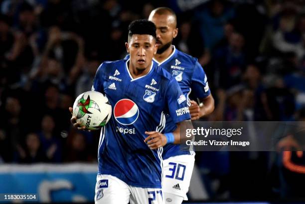 Sebastian Salazar of Millonarios runs to celebrate his first scored goal from his team to Independiente Santa Fe, during a match between Millonarios...