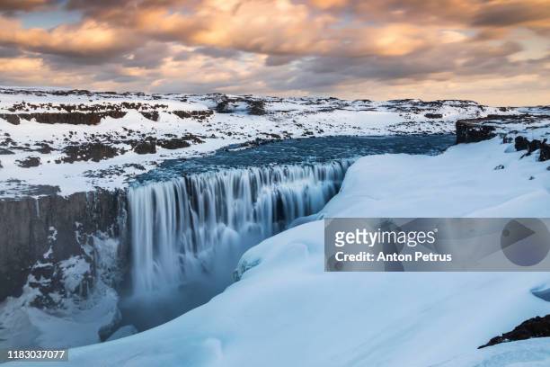 dettifoss waterfall in northeast iceland at wwinter sunset - dettifoss falls stock pictures, royalty-free photos & images