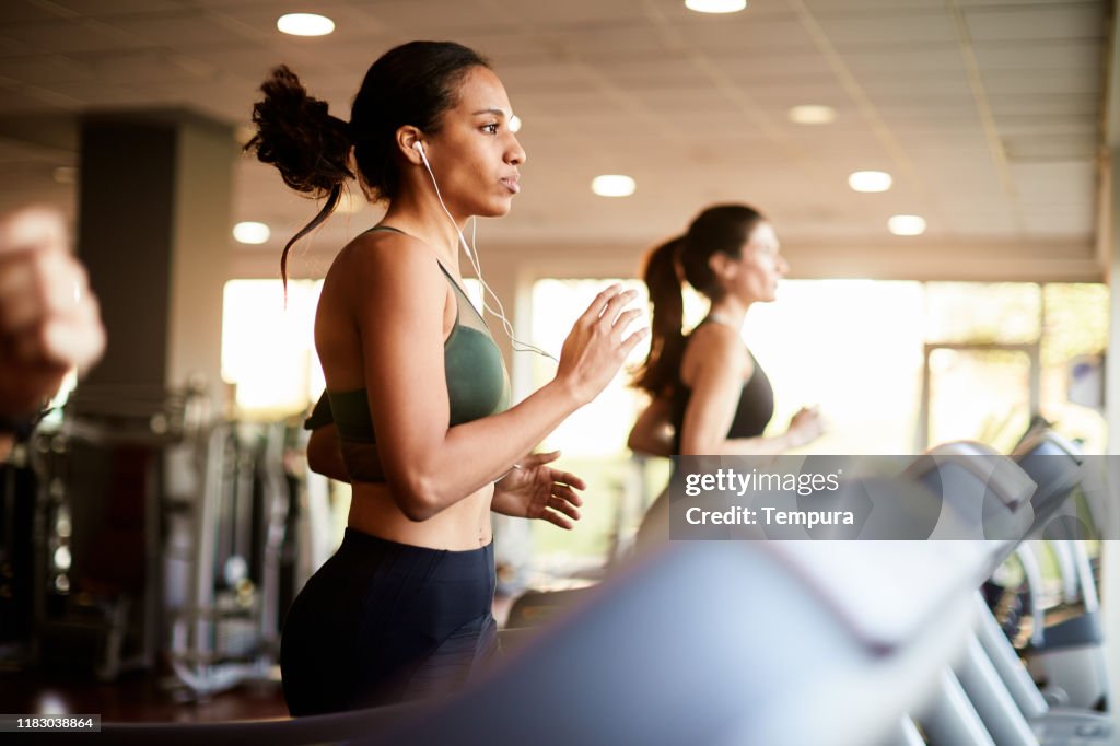 Young woman exercising on treadmill