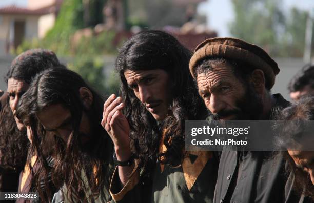 Member of the Islamic state ISIS militants stand alongside their weapons, as they surrendered to government in Jalalabad, Nangarhar, Afghanistan on...