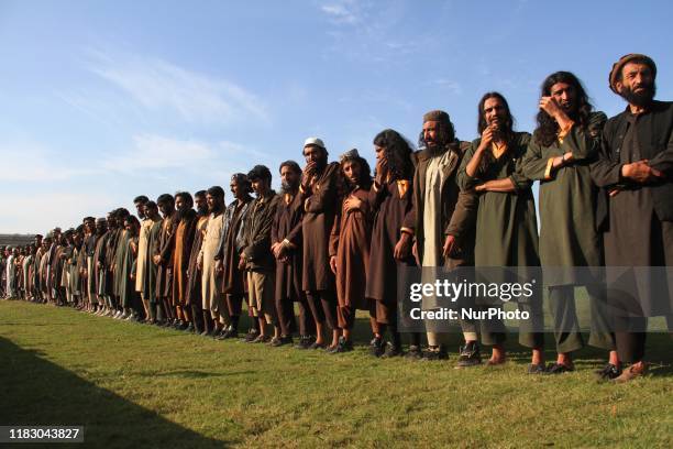 Member of the Islamic state ISIS militants stand alongside their weapons, as they surrendered to government in Jalalabad, Nangarhar, Afghanistan on...