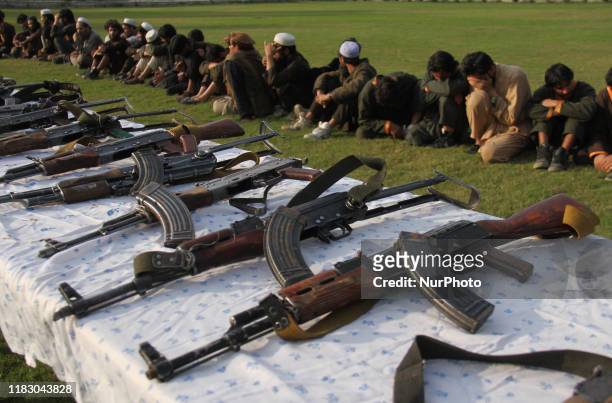 Member of the Islamic state ISIS militants stand alongside their weapons, as they surrendered to government in Jalalabad, Nangarhar, Afghanistan on...