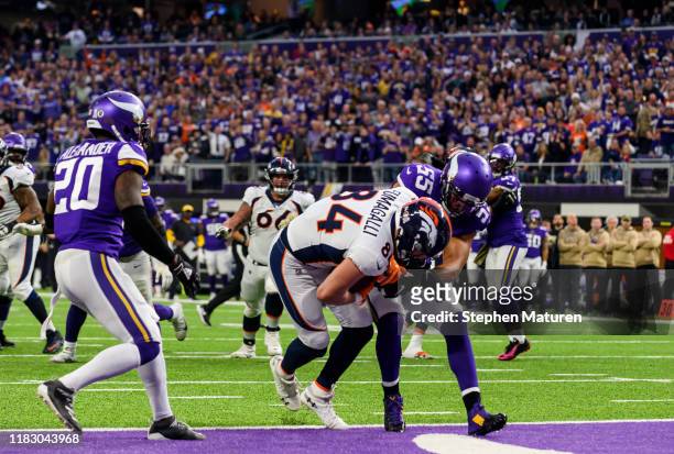 Troy Fumagalli of the Denver Broncos catches the ball for a touchdown in the first quarter of the game against the Minnesota Vikings at U.S. Bank...