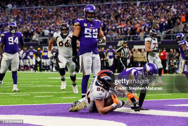 Troy Fumagalli of the Denver Broncos catches the ball for a touchdown in the first quarter of the game against the Minnesota Vikings at U.S. Bank...