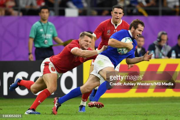 France's Camille Lopez is tackled by Wales' Dan Biggar during the Rugby World Cup 2019 Quarter Final match between Wales and France at Oita Stadium...