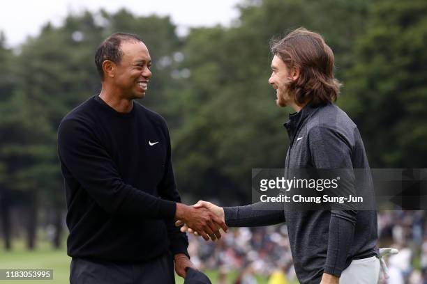 Tiger Woods of the United States and Tommy Fleetwood of England shake hands after holing out on the 9th green during the first round of the ZOZO...