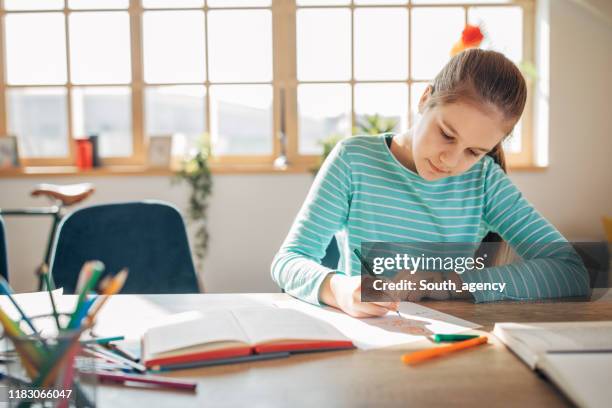 young girl student studying alone on class in private school - young girls homework stock pictures, royalty-free photos & images