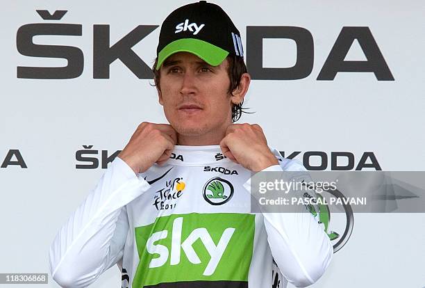 Britain's Geraint Thomas celebrates his white jersey of best young on the podium at the end of the 172,5 km and fourth stage of the 2011 Tour de...