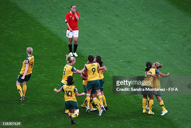 Kyah Simon of Australia celebrates with team mates after scoring her team's first goal while Kristine Wigdahl Hegland looks dejected during the FIFA...