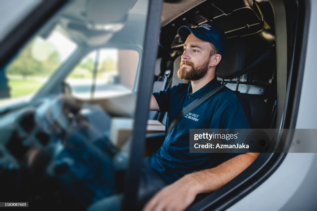 Young Male Gig Driver Waiting to Get Started on Deliveries