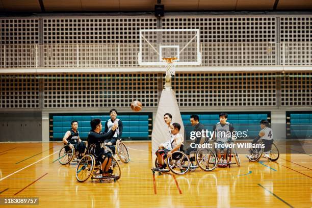 professional wheelchair basketball team playing a game and practicing - wheelchair basketball team stock pictures, royalty-free photos & images