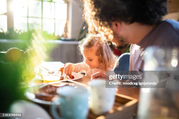 enjoying a wholesome breakfast with dad - healthy eating family stock pictures, royalty-free photos & images