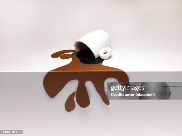 conceptual cup of spilled coffee on a table - drinkwater kante stock-fotos und bilder