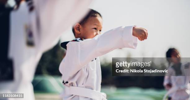 cute little asian boy taking karate - child judo stock pictures, royalty-free photos & images