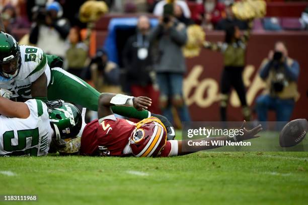 Dwayne Haskins of the Washington Redskins is sacked by Frankie Luvu of the New York Jets during the second half at FedExField on November 17, 2019 in...