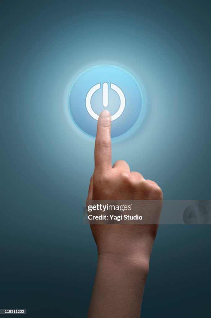 A woman's hand tapping on power button