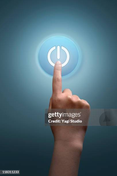 a woman's hand  tapping on power button - push button stock pictures, royalty-free photos & images