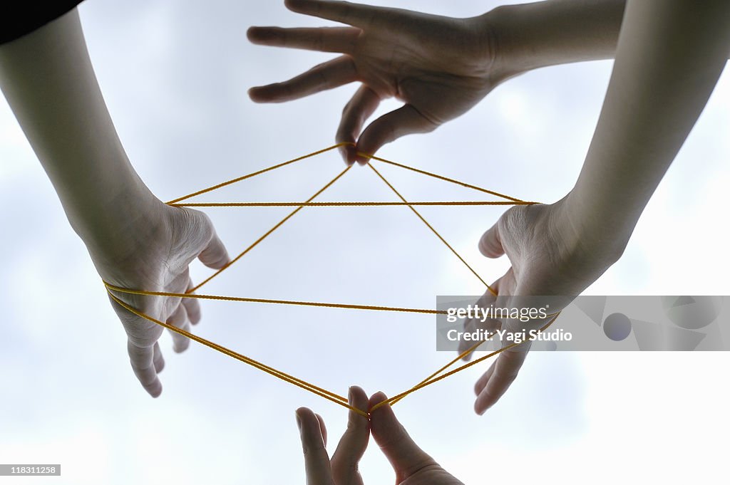 Woman and man playing cat's cradle,close-up of the