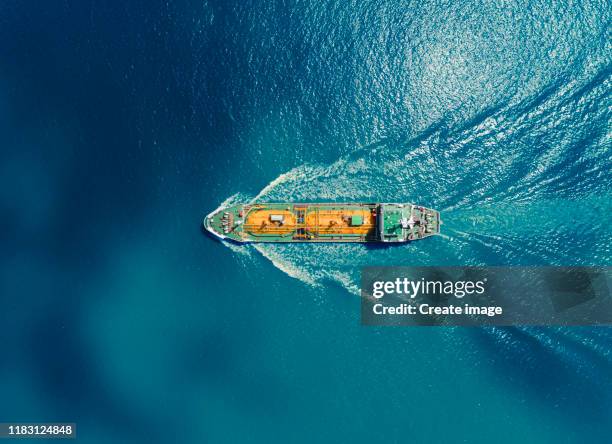 aerial top view oil or lpg ship tanker transportation oil/lpg from refinery on the blue sea. - offshore platform aerial stock pictures, royalty-free photos & images
