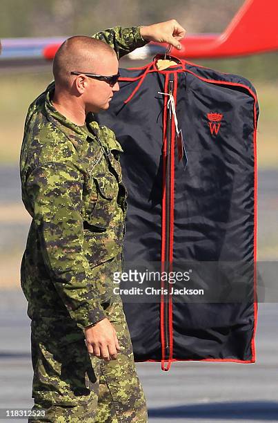 Canadian Soldiers load Prince William, Duke of Cambridge's suits onto the Royal Plane at Yellowknife Airport on July 6, 2011 in Yellowknife, Northern...