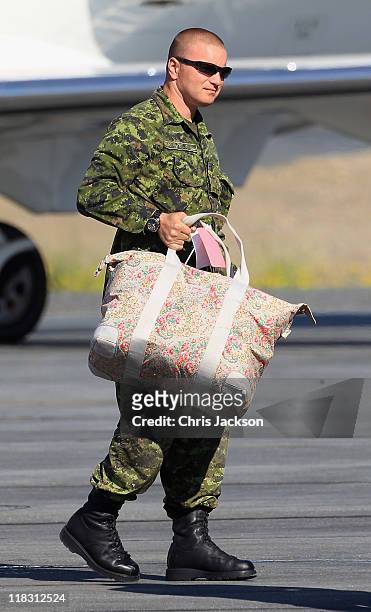 Canadian Soldiers load Prince William, Duke of Cambridge and Catherine, Duchess of Cambridge's luggage onto the Royal Plane at Yellowknife Airport on...