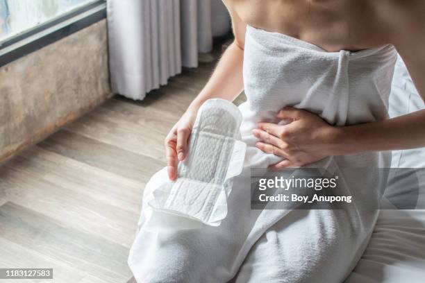 woman holding sanitary napkins or menstruation pad before wearing it. women using it during menstruation to avoid damage to clothing. - period stock pictures, royalty-free photos & images