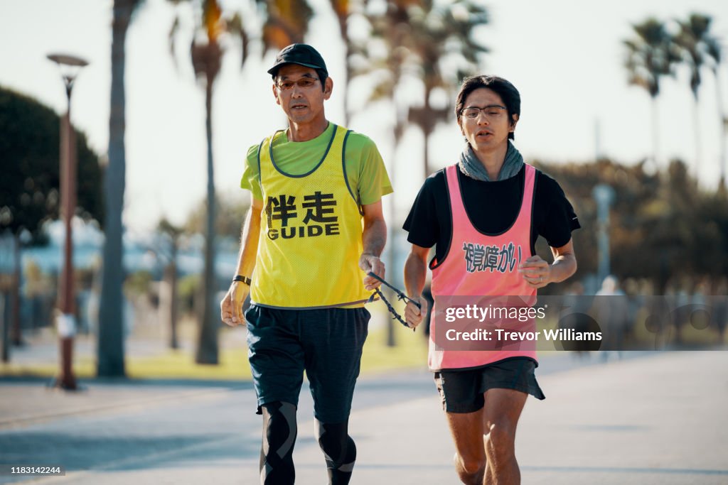 Blind marathon athlete running with his guide