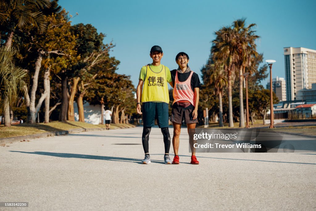 Portrait of a blind marathon athlete and his guide