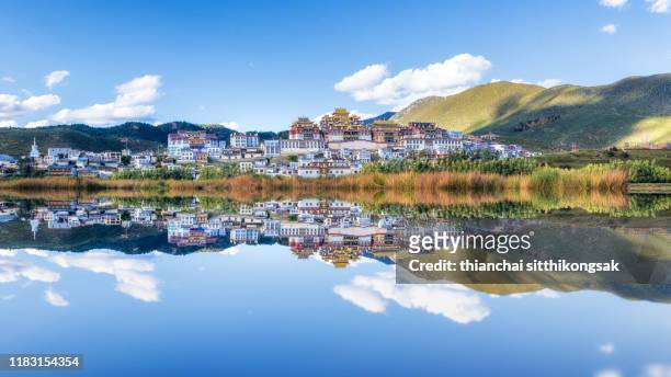 the reflection of songzanlin temple - songzanlin monastery stock-fotos und bilder